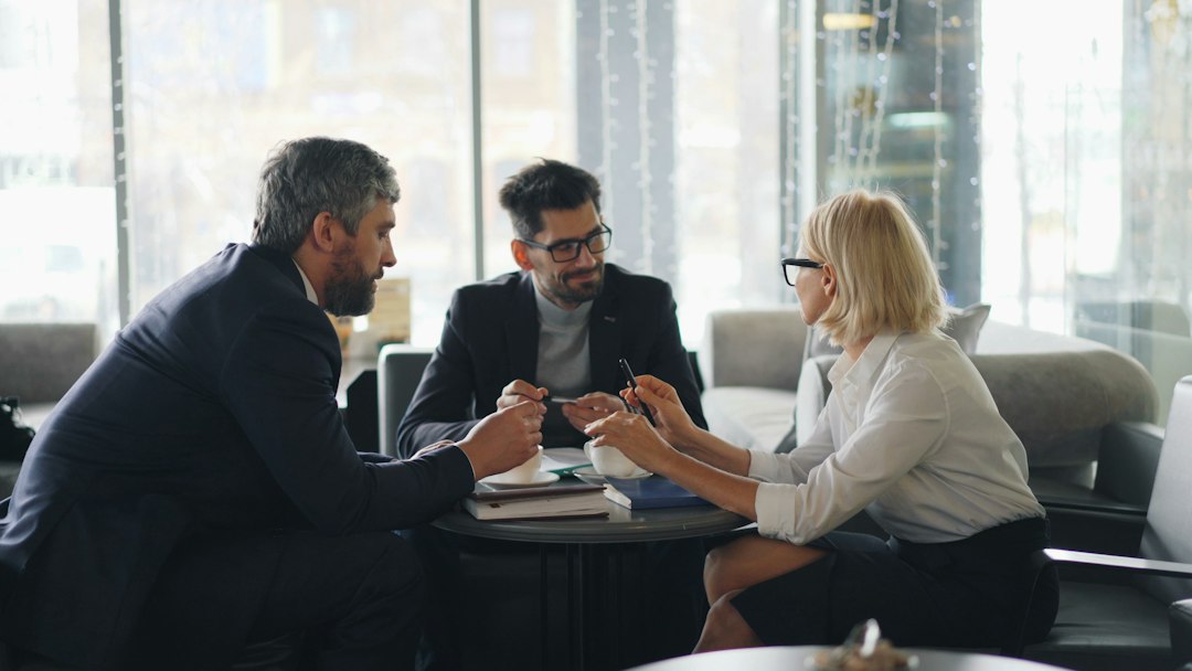 Executive travel agency leadership and advisors in strategic consultation meeting
