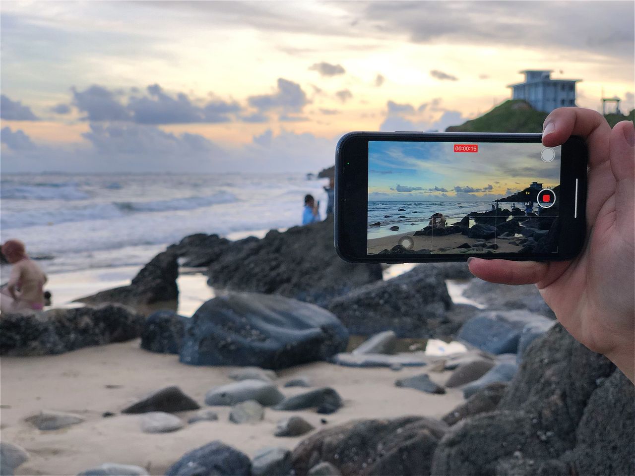 Travel advisor recording raw video footage on phone at tropical resort for automated Reels creation