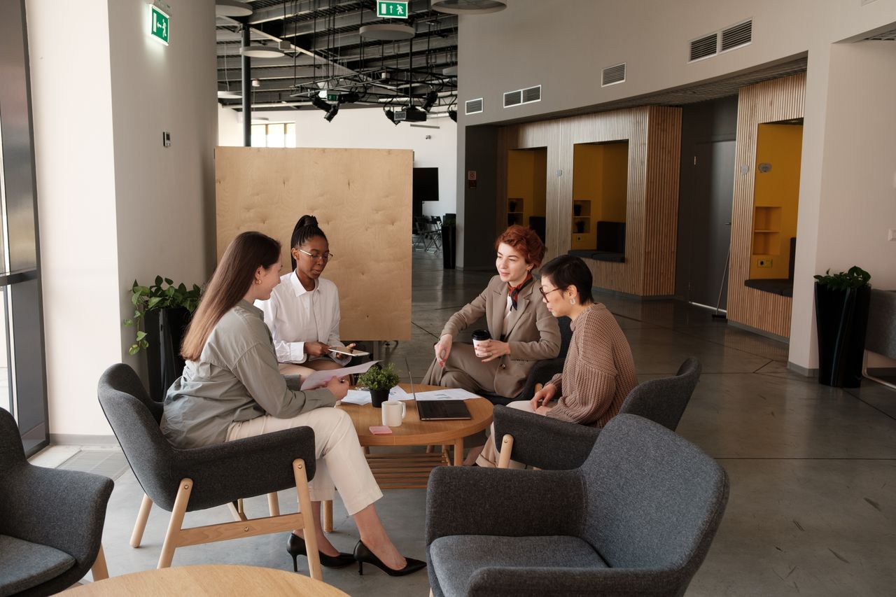 Travel agency owners and advisors collaborating in modern executive office